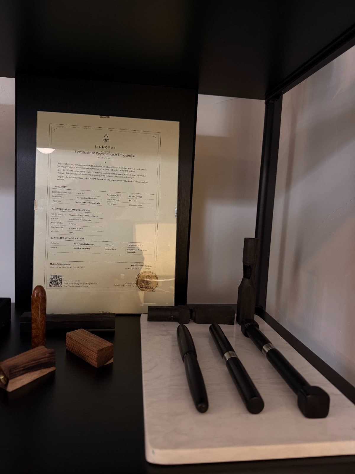 LIGNORAE writing instruments displayed at MONOM beside the certificate of provenance