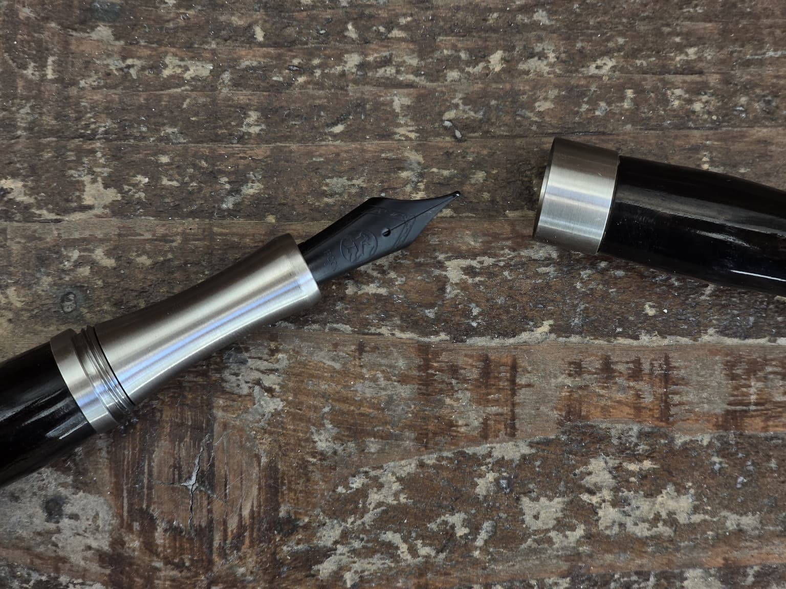 LIGNORAE fountain pen nib photographed on worn wood