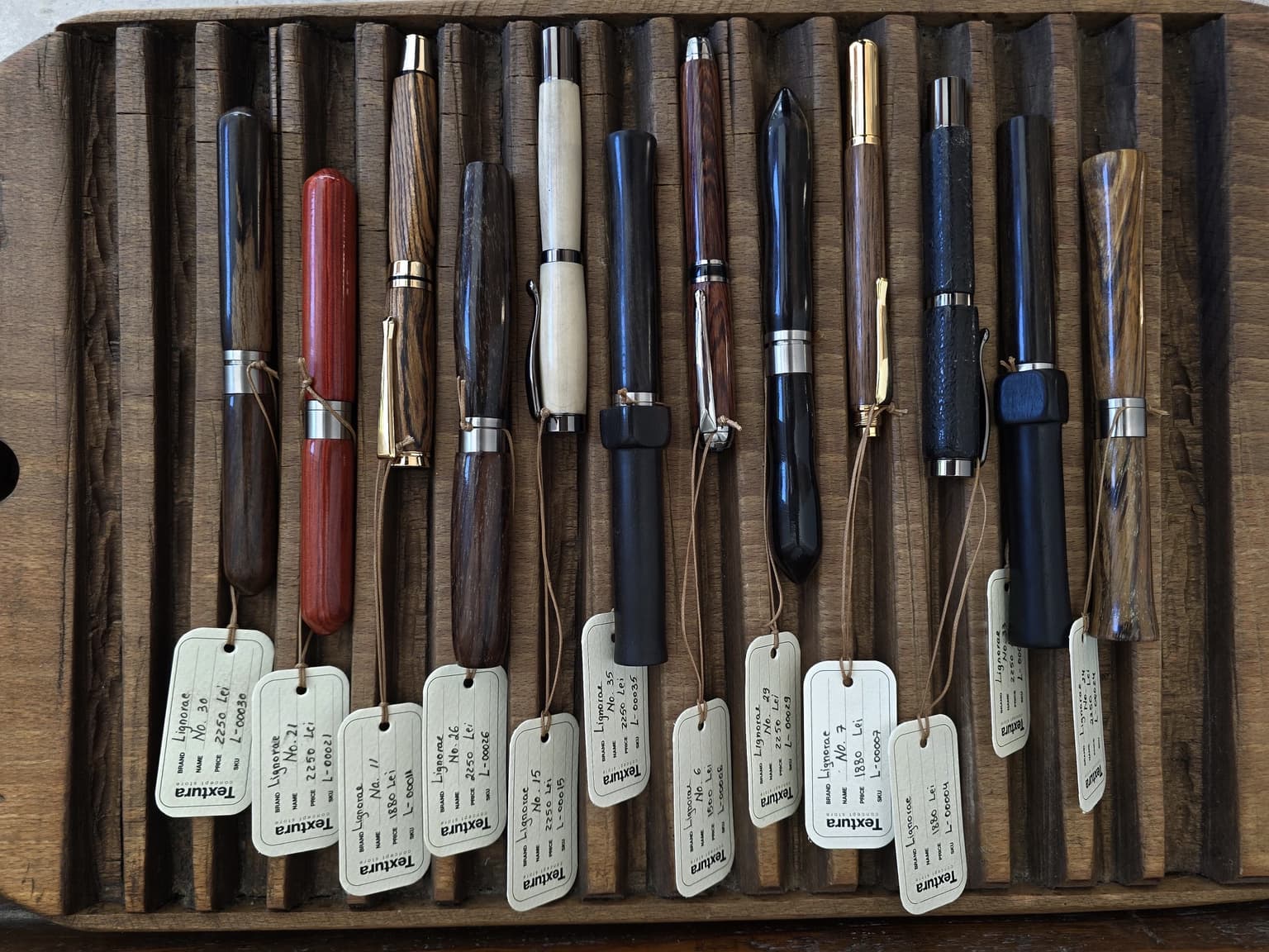 Top view of LIGNORAE writing instruments with numbered TEXTURA tags